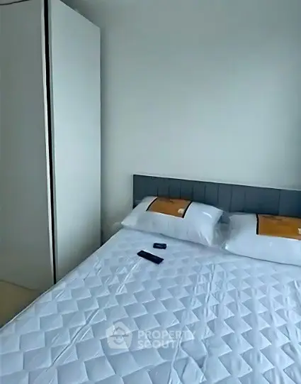 Modern bedroom with sleek wardrobe and cozy bed in a stylish apartment.