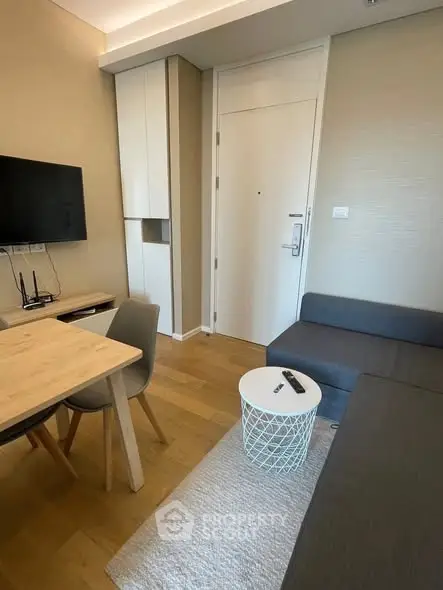 Modern living room with sleek furniture and wall-mounted TV