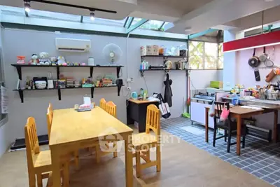 Spacious kitchen with wooden dining table and open shelving