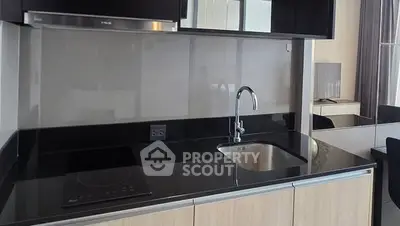 Modern kitchen with sleek black countertops and built-in appliances