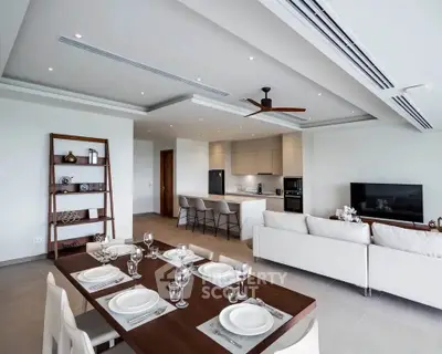 Modern open-plan living and dining area with sleek kitchen and stylish decor.
