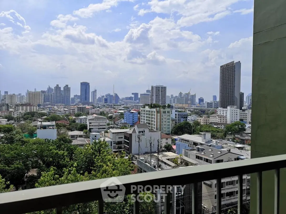 Stunning cityscape view from a high-rise balcony overlooking urban skyline.