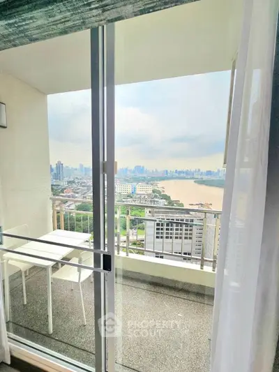 Stunning high-rise balcony view with city skyline and river, perfect for urban living.