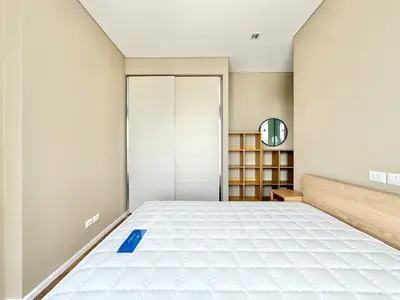 Modern minimalist bedroom with built-in wardrobe and stylish shelving