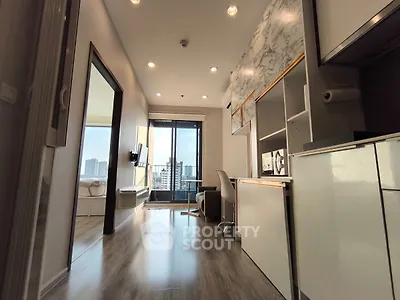 Modern apartment interior with sleek design and city view balcony, featuring open layout and stylish furnishings.