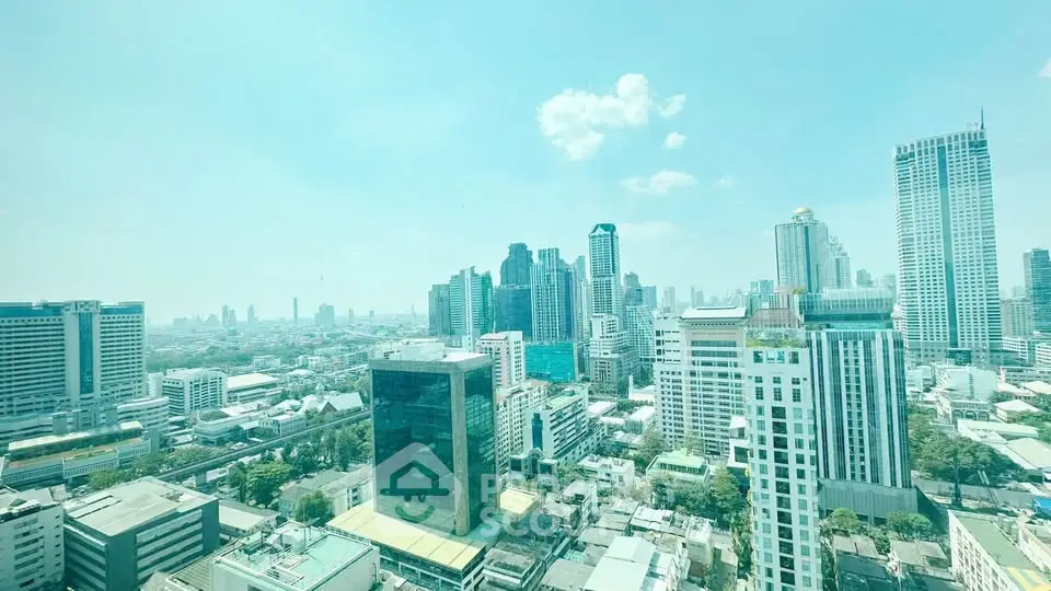 Stunning cityscape view from a high-rise building showcasing urban skyline and modern architecture.