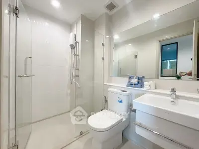 Modern bathroom with glass shower enclosure and sleek fixtures