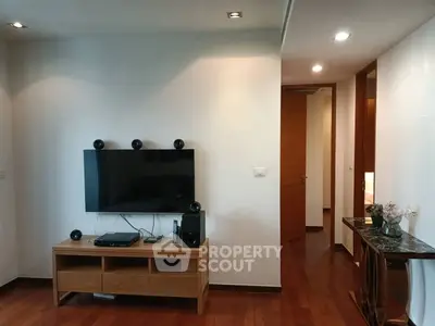 Modern living room with sleek TV setup and wooden flooring