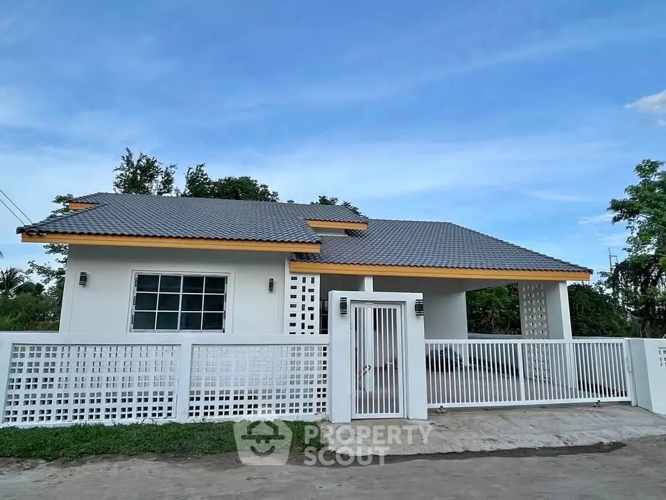 Charming single-story house with modern design and spacious front yard.