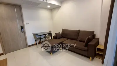 Cozy living room with brown sofa and small dining table, perfect for modern living.