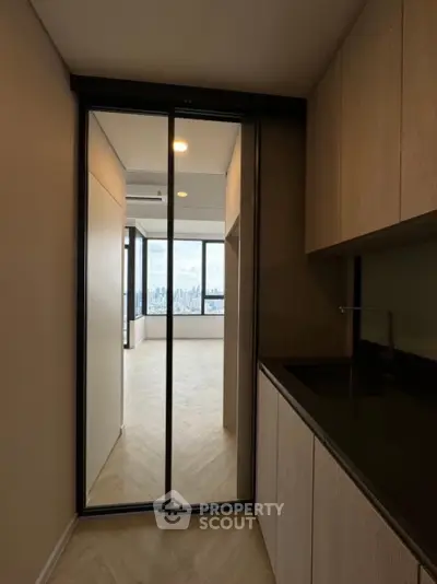 Modern apartment interior with sleek kitchen and stunning city view