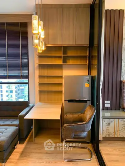 Modern living room with stylish furniture and built-in shelving, featuring a cozy seating area and elegant lighting.