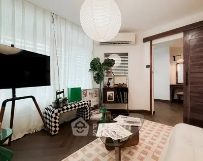 Stylish living room with modern decor, featuring a cozy seating area, chic coffee table, and ambient lighting.