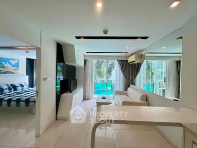 Modern open-plan living room with sleek design and large windows offering a stunning view of the cityscape.