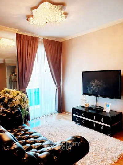 Luxurious living room with elegant chandelier and plush leather sofa