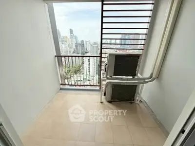 High-rise balcony with city view and air conditioning unit, perfect for urban living.