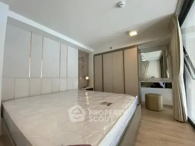 Modern bedroom with large bed and stylish decor in a bright apartment.
