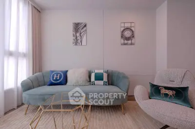 Elegant living room with plush sofa, modern armchair, and stylish decor in a bright, airy space.