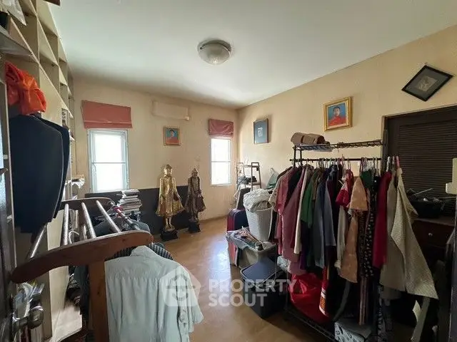 Spacious storage room with clothing racks and natural light