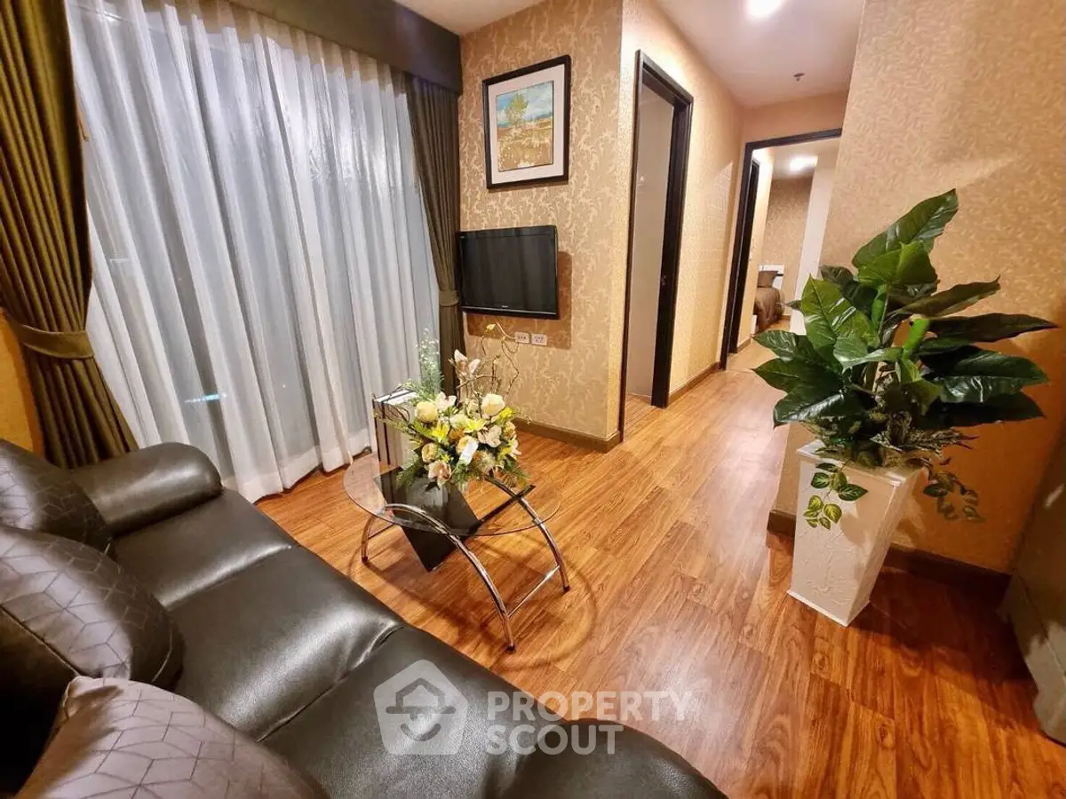 Elegant living room with hardwood floors, cozy sofa, and stylish decor in modern apartment.