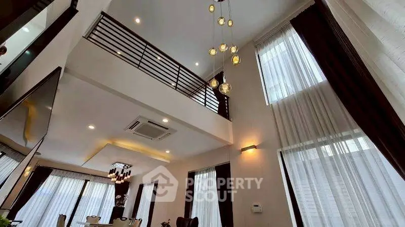 Luxurious modern living room with high ceilings and elegant lighting