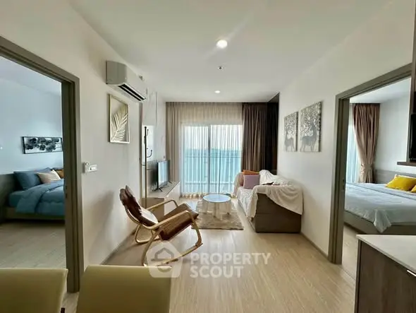 Modern living room with ocean view, stylish furniture, and natural light