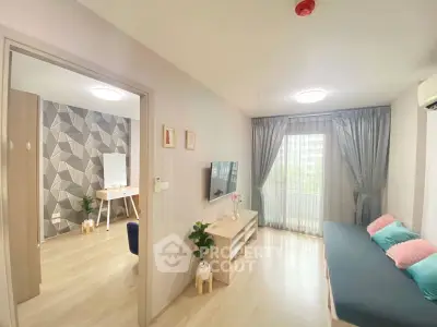 Modern living room with stylish decor and natural light, featuring a cozy seating area and a view of the outdoors.