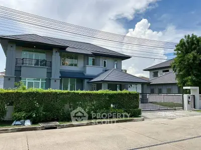 Elegant modern house with lush greenery and spacious driveway in a serene neighborhood.