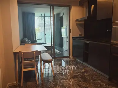 Modern open-plan kitchen and living area with sleek design and marble flooring