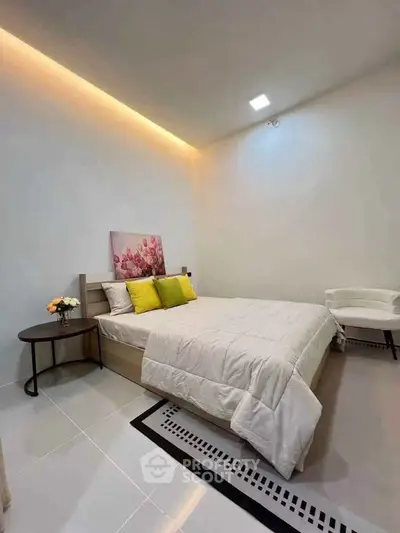Modern bedroom with stylish decor and cozy ambiance, featuring a comfortable bed and elegant lighting.