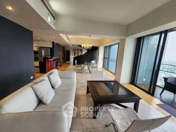 Luxurious open-plan living room with stunning city view and modern furnishings.