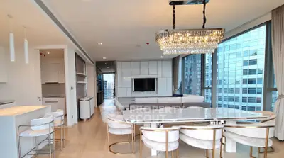Luxurious modern living room with elegant chandelier and panoramic city views.