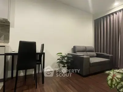 Modern living room with sleek furniture and elegant decor, featuring a cozy sofa and dining area.