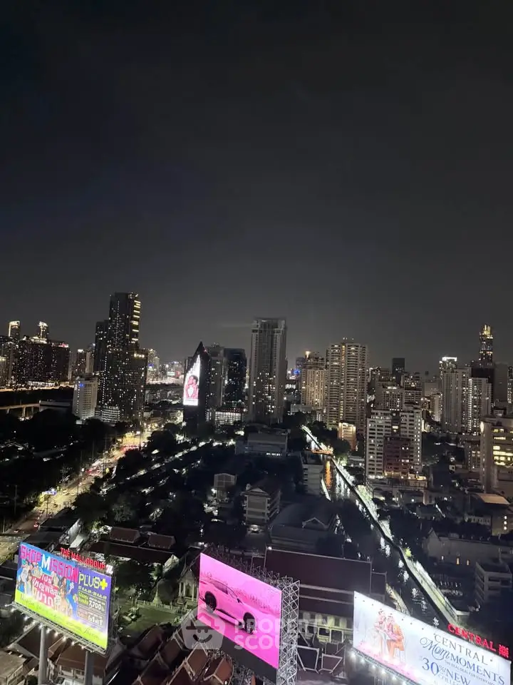 Stunning cityscape view from a high-rise building showcasing vibrant urban lights and skyline.