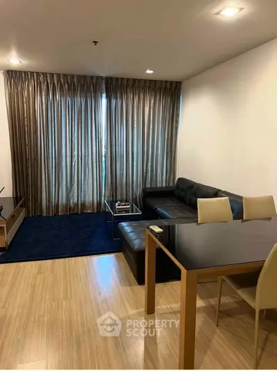 Modern living room with sleek furniture and elegant curtains