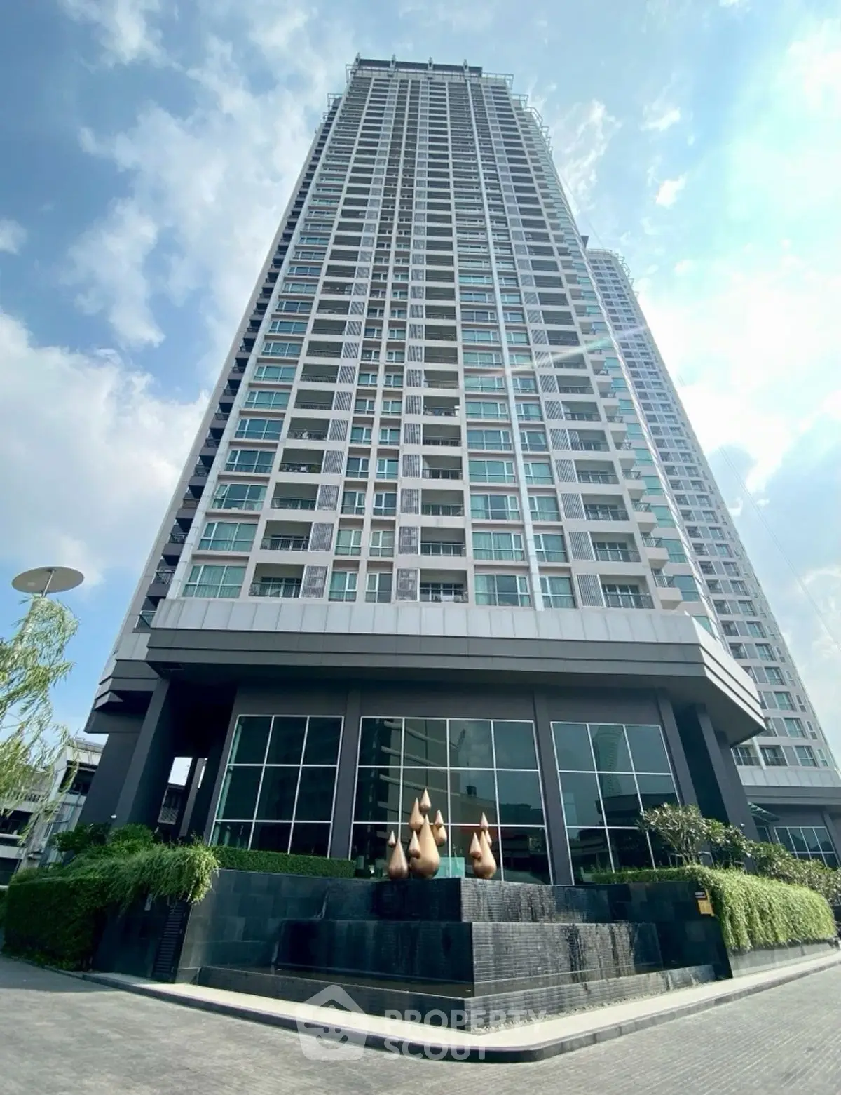 Stunning high-rise building with modern architecture and lush landscaping.
