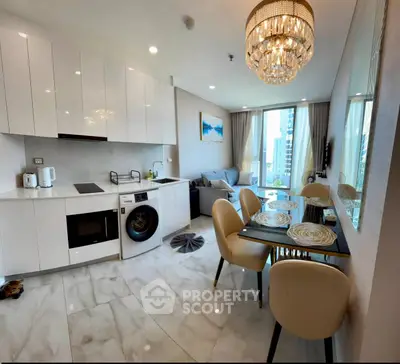 Luxurious modern kitchen and living area with chandelier and city view