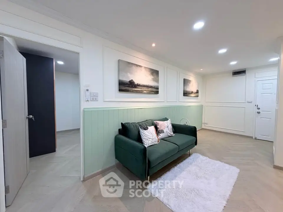 Stylish living room with green sofa and modern decor in a cozy apartment.