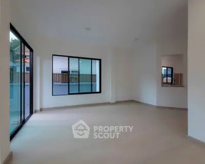 Spacious empty living room with large windows and modern design