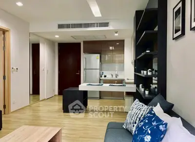 Modern open-plan living room with stylish kitchen and cozy seating area