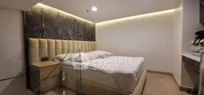 Luxurious bedroom with modern design and ambient lighting, featuring a plush bed and elegant decor.