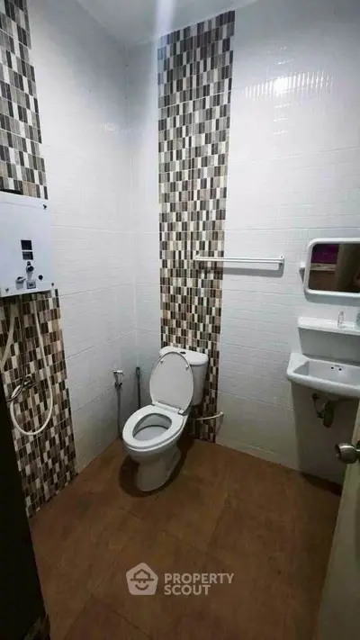 Modern bathroom with stylish tile design and compact layout