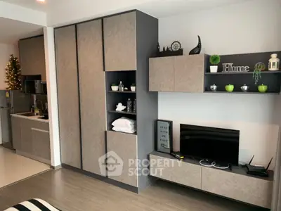 Modern studio apartment with sleek cabinetry and compact kitchen