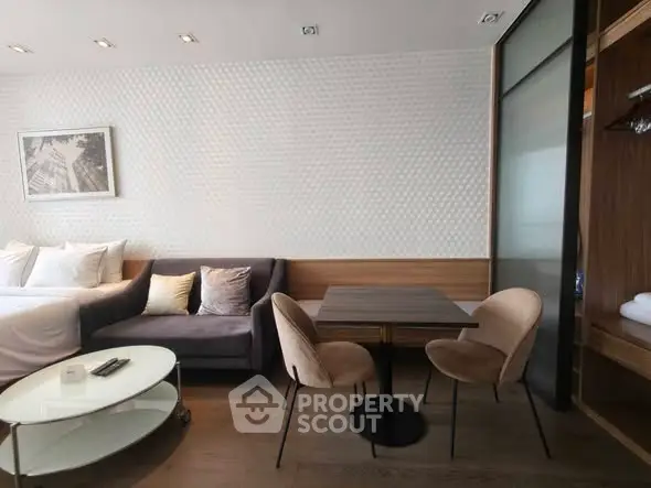 Modern studio apartment with cozy living area and stylish dining setup