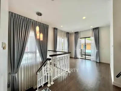 Spacious modern living area with elegant curtains and wooden flooring