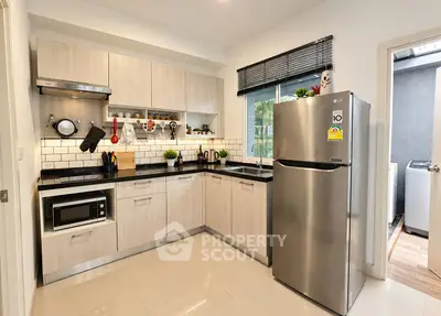 Modern kitchen with sleek appliances and stylish cabinetry in a contemporary home.