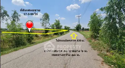 Scenic land plot for sale with clear road access and lush greenery.