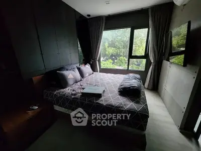 Cozy bedroom with large window and modern decor