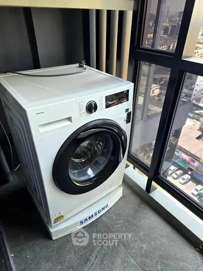 Modern high-rise apartment with Samsung washing machine and city view