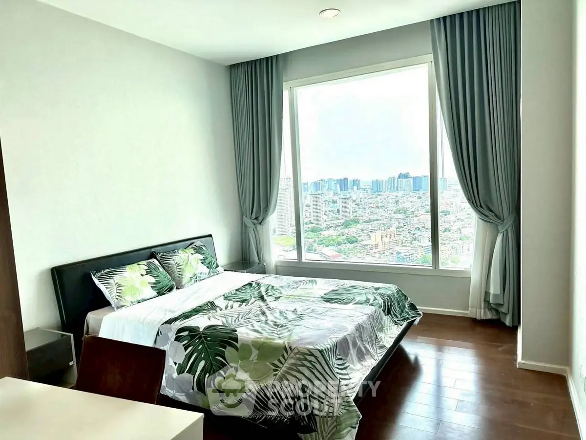 Bright bedroom with large window offering stunning city view, modern decor and hardwood floors.
